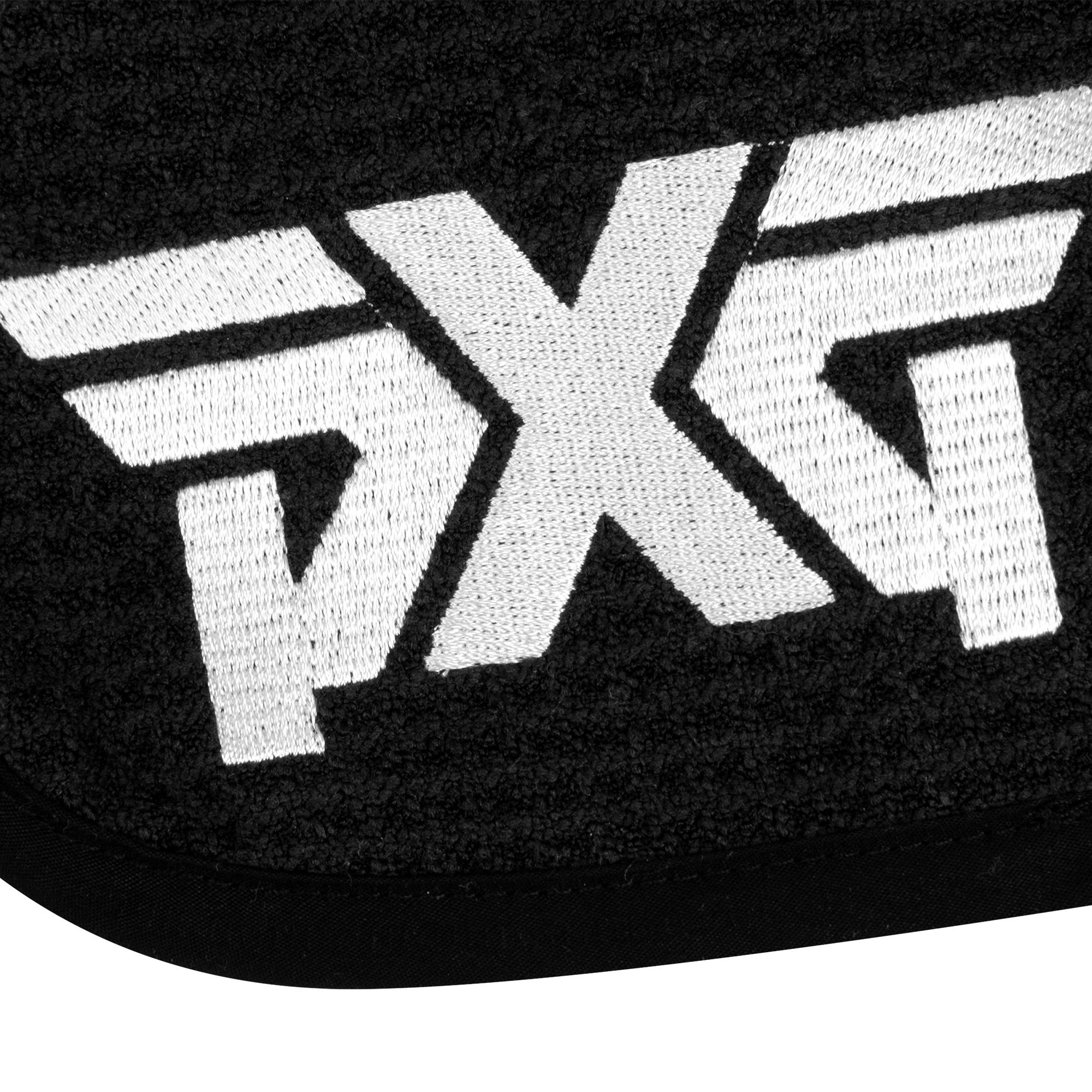 Close-up of white PXG logo on black background on towel